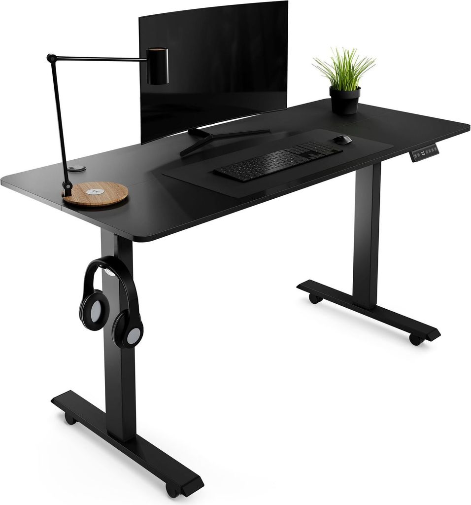 A black adjustable standing desk with a monitor, keyboard, mouse, lamp, headphones, and a potted plant.