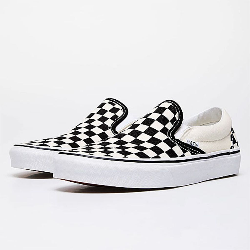 A pair of Vans Classic Slip-On sneakers with a checkerboard pattern.