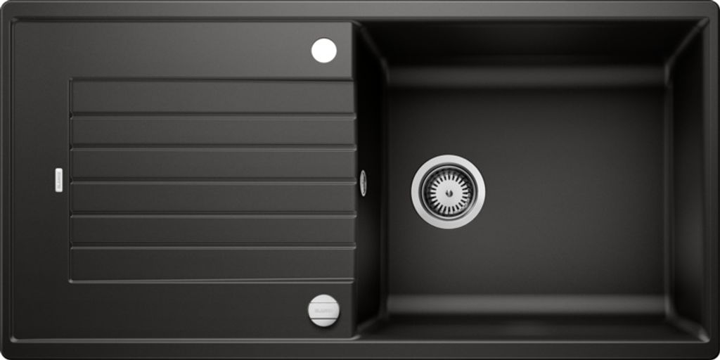 A top-down view of a black kitchen sink with a drainboard.