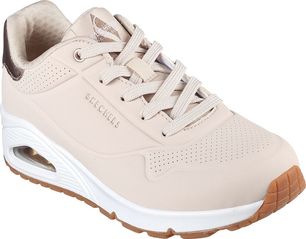 A studio shot of a single beige Skechers sneaker.