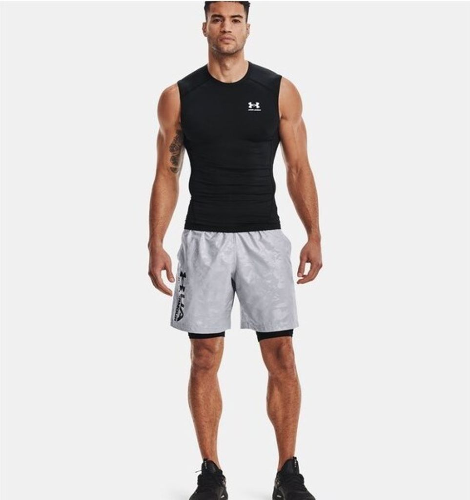 A man wearing athletic clothing stands against a white background.
