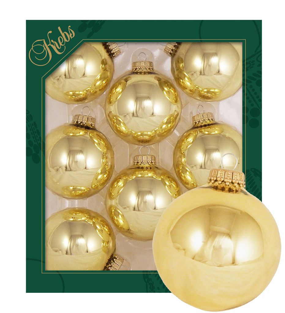 A set of gold Christmas ornaments in a box, with one ornament prominently displayed in the foreground.