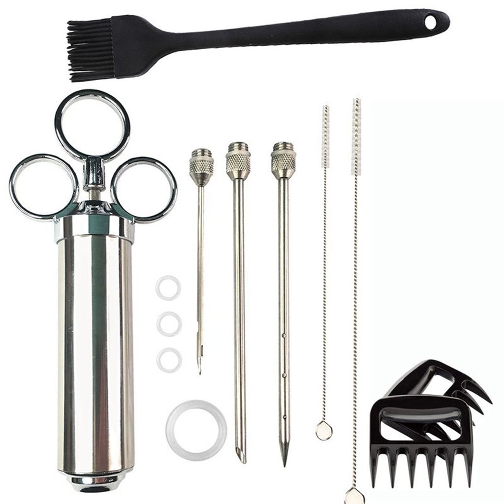 A collection of barbecue tools laid out on a white background.