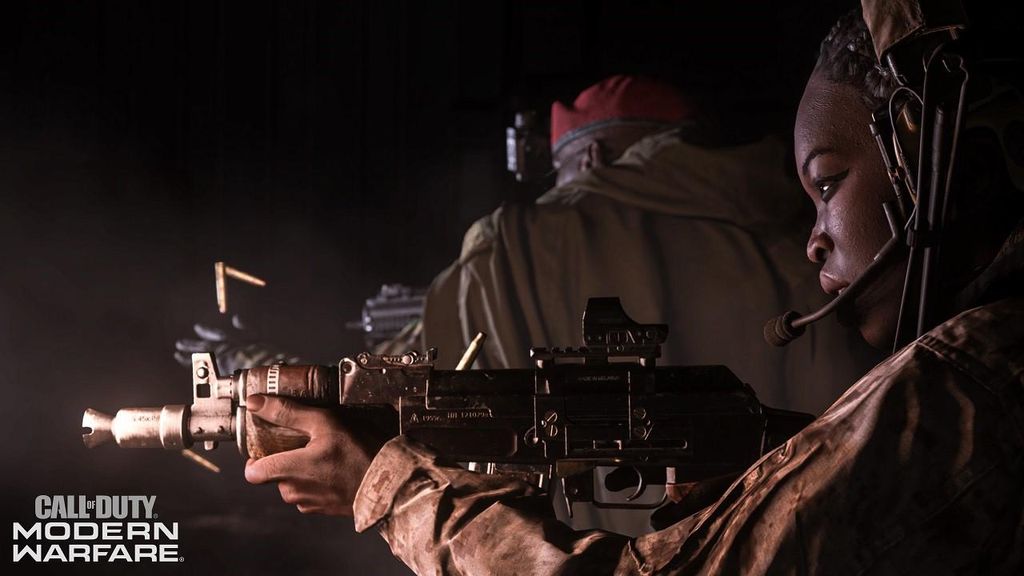 Two soldiers in tactical gear, one aiming a rifle, in a dark environment.