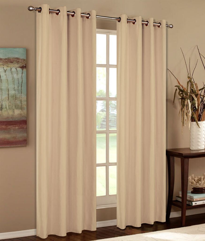 A window with beige curtains and a painting on the wall.