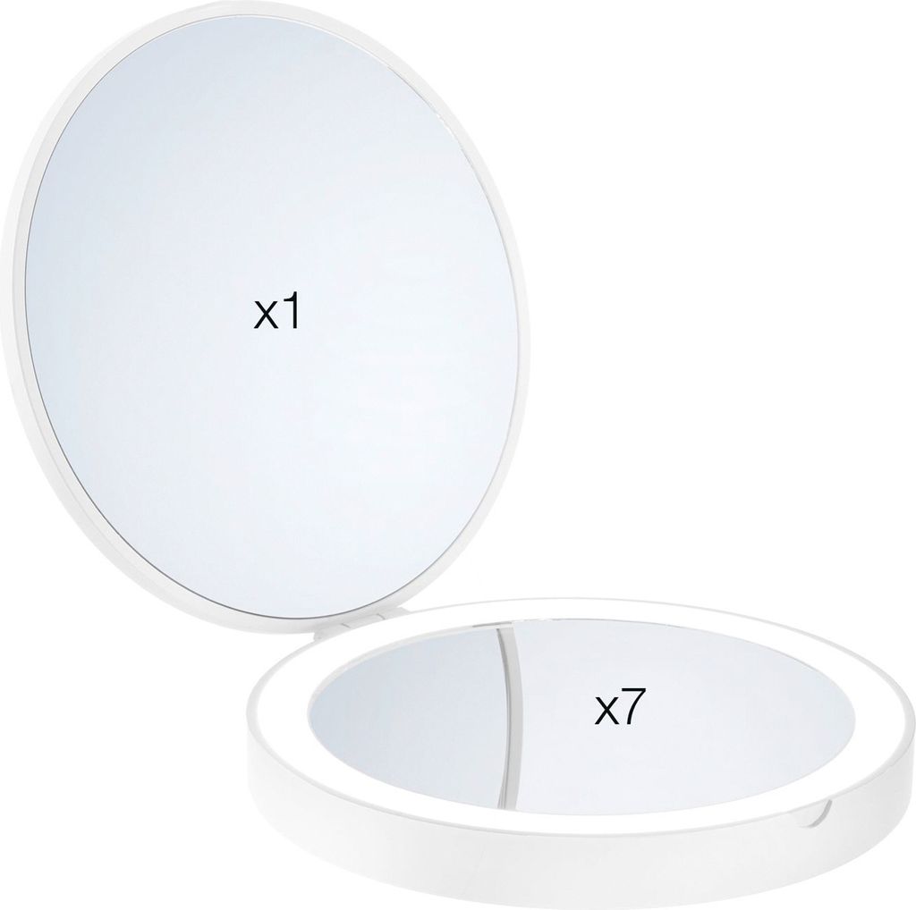 A white makeup mirror with two sides, one with normal magnification and the other with 7x magnification, is shown open against a white background.