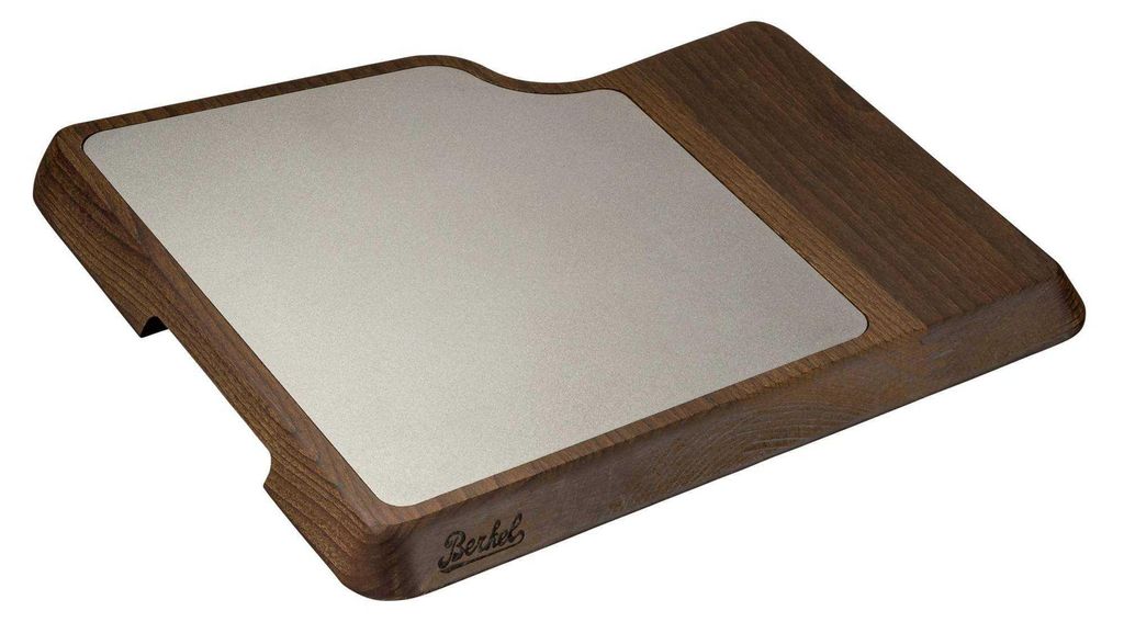 A wooden cutting board with a metal insert, shown from a diagonal angle against a white background.