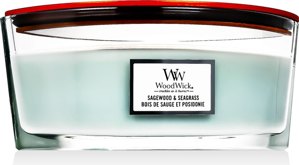 A close-up studio shot of a WoodWick candle in a glass jar with a red lid.