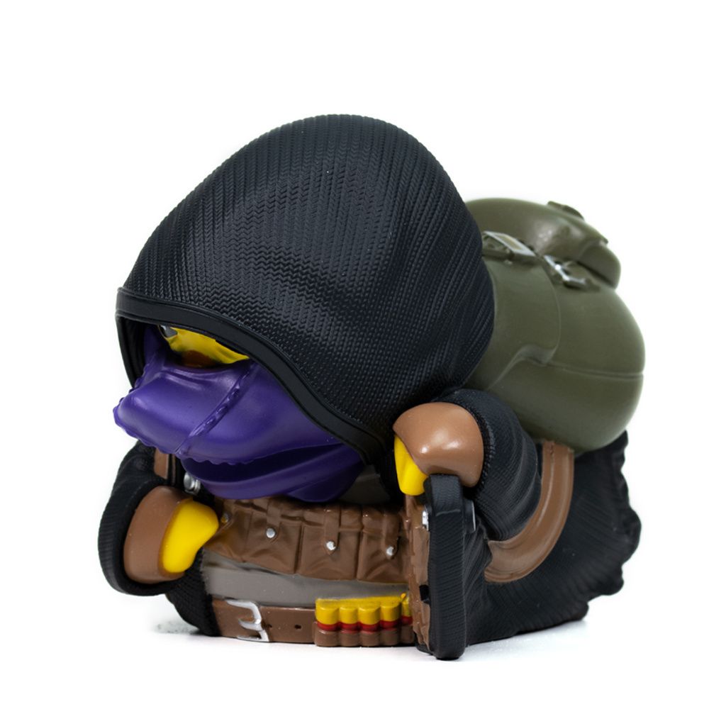 A small, stylized figurine of a character with a hood and backpack, presented against a white background.