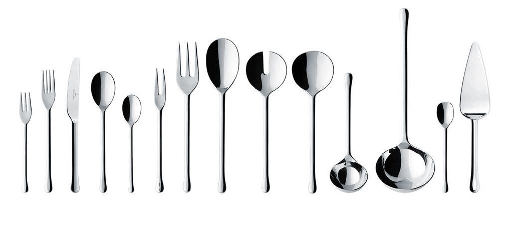 A collection of silverware arranged in a line against a white background.