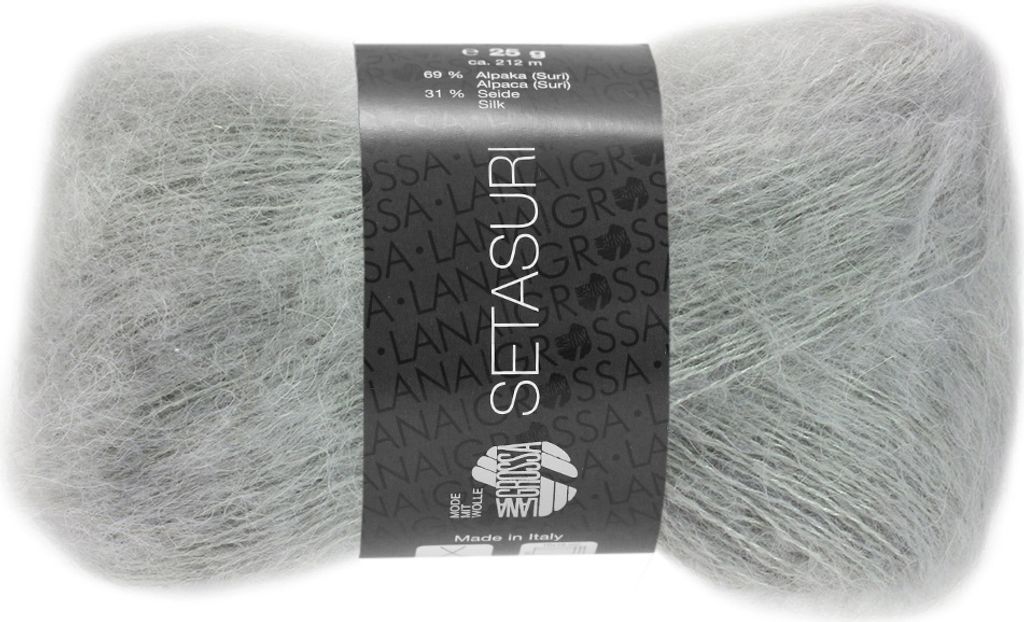 A ball of light gray yarn with a label wrapped around it.