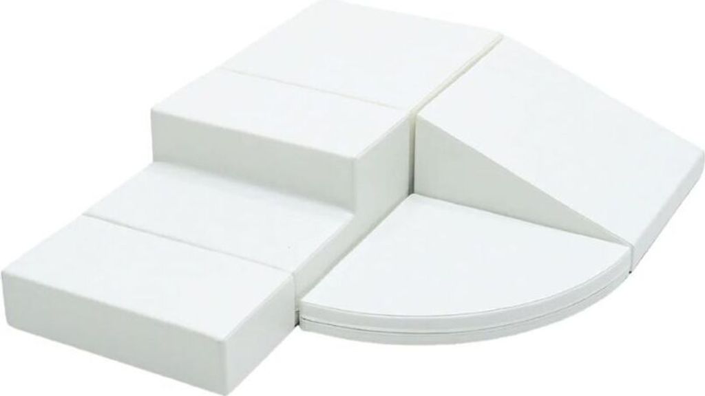 A set of white foam blocks arranged in a playful, modular structure, resembling steps and a ramp.