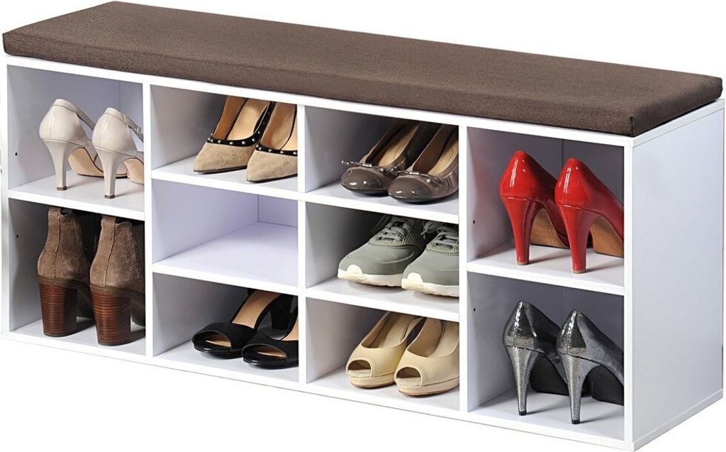A shoe cabinet with a padded seat on top, filled with various shoes.