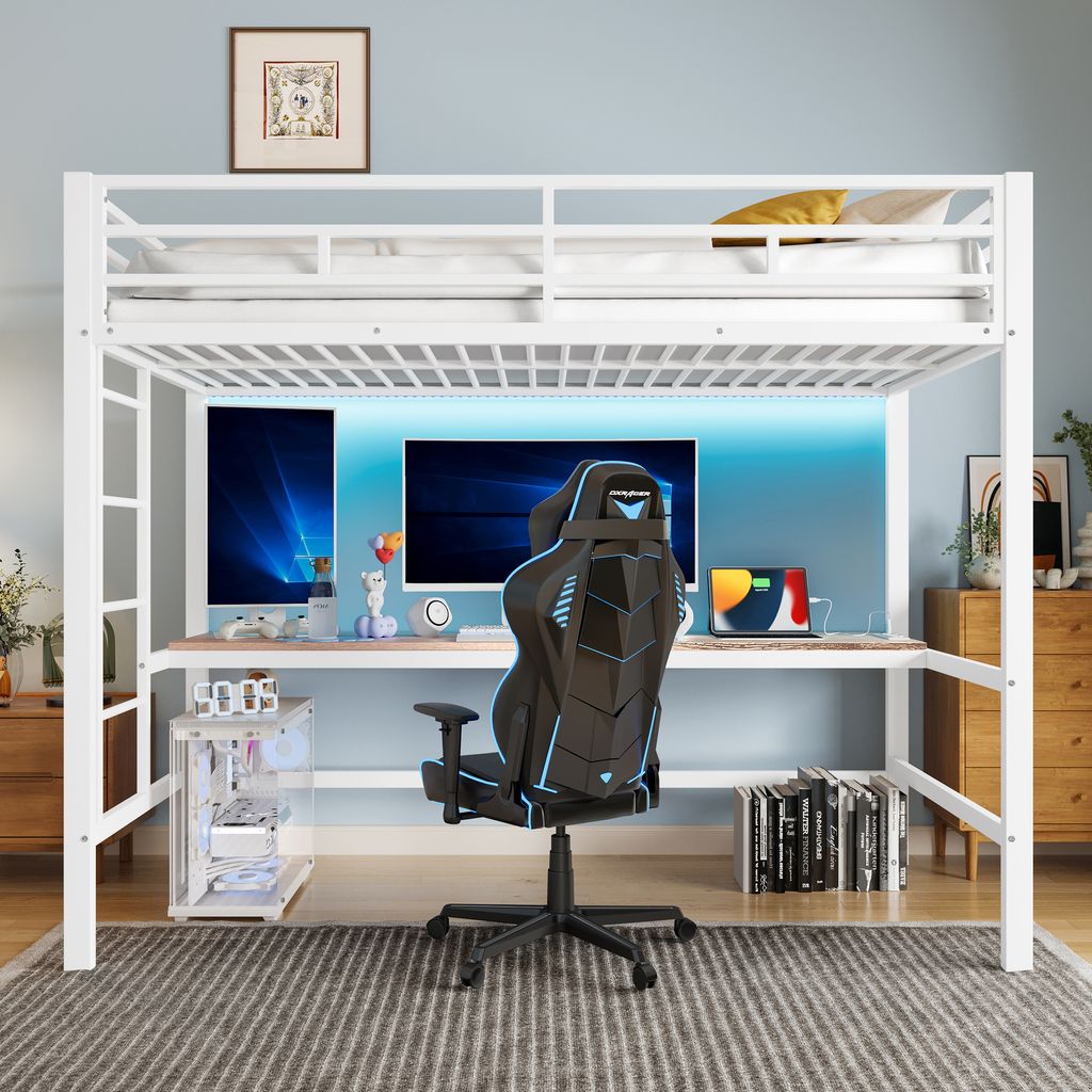 A white metal loft bed with a desk and gaming chair underneath, set up in a room with a blue wall and LED lighting.