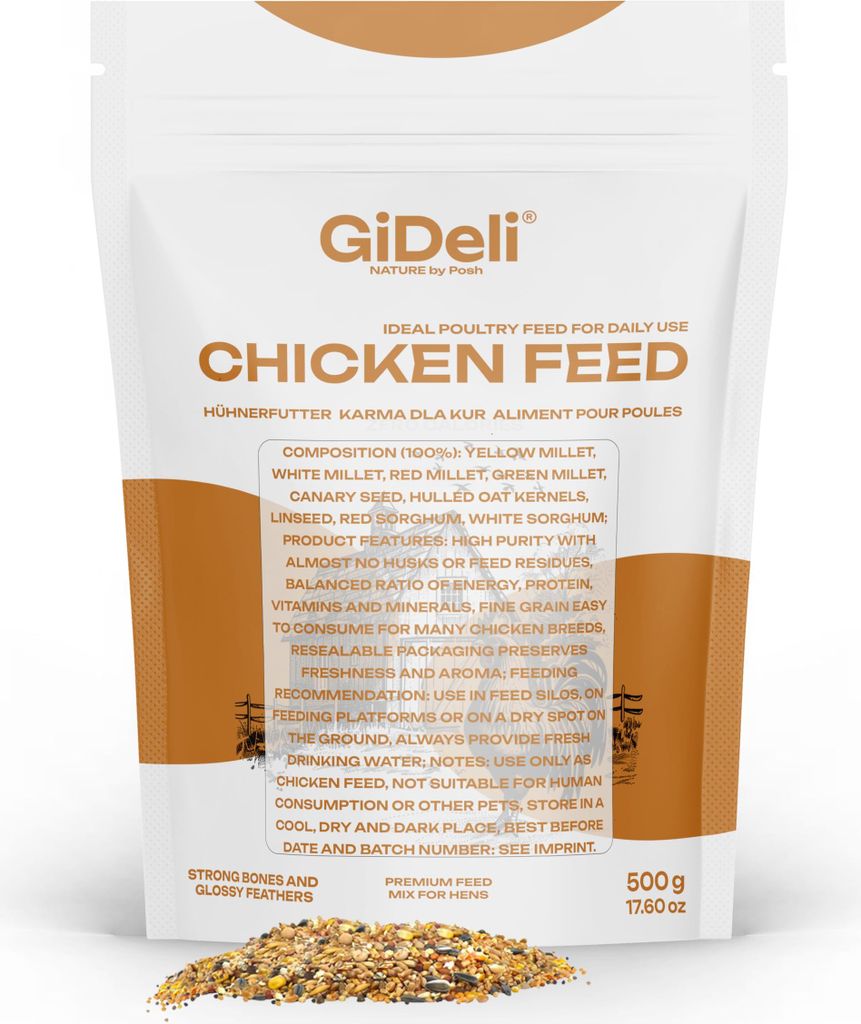 A bag of chicken feed with some feed spilled in front of it.