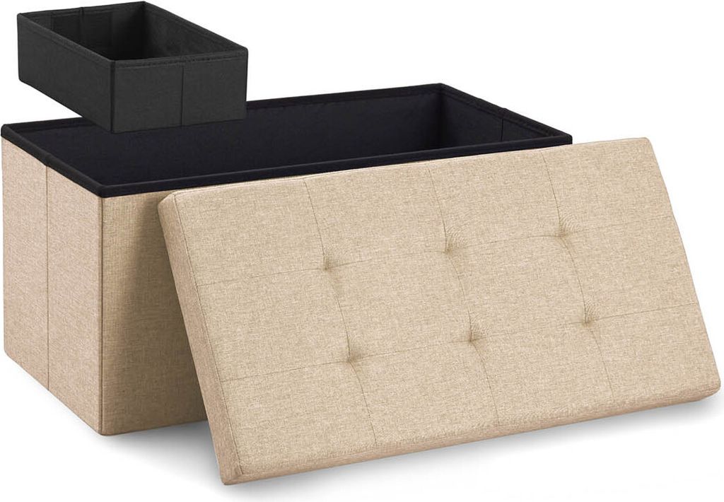 A beige storage ottoman with its lid open, revealing a black interior and a black insert box on top. The lid is tufted with buttons.