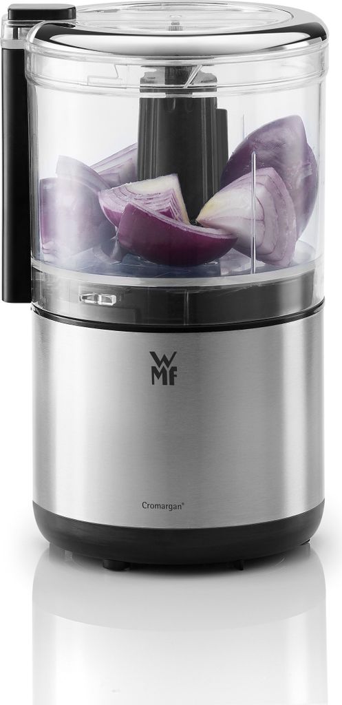 A close-up studio shot of a WMF KÜCHENminis Zerkleinerer (chopper) filled with chopped red onions, set against a white background.