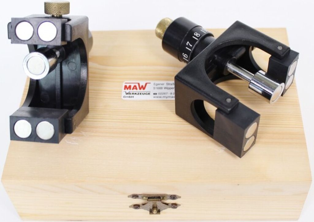 Two precision measuring tools are placed on a wooden box.