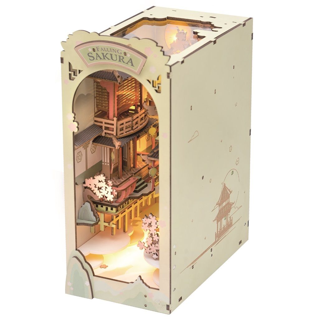 A 3D wooden model of a Japanese scene with cherry blossoms and a building, illuminated by internal lights.