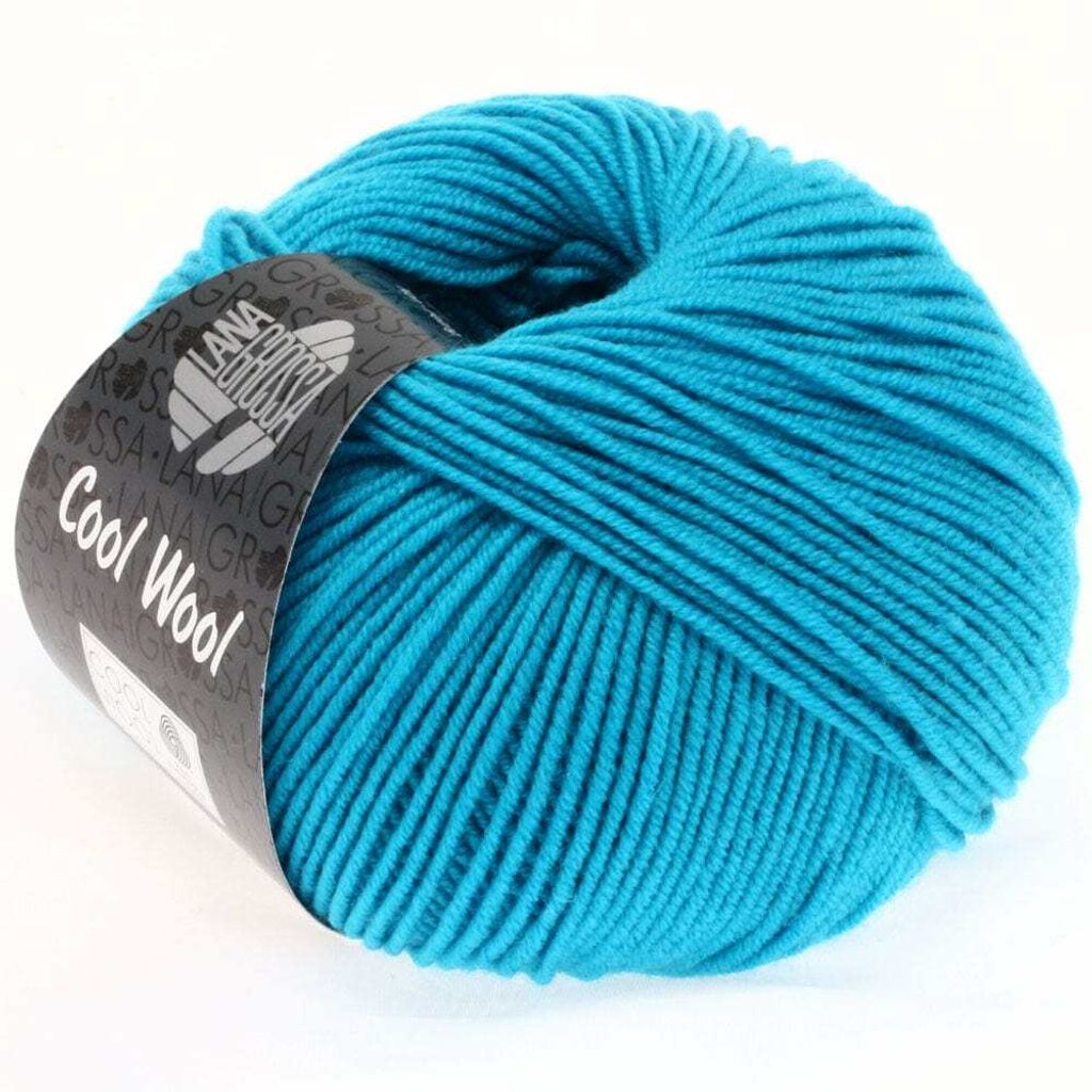 A ball of turquoise yarn with a label.