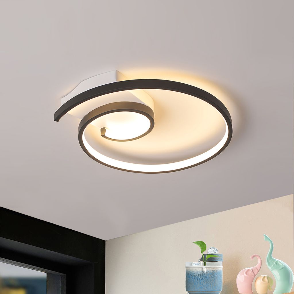 A modern spiral LED ceiling light is shown mounted on a white ceiling.