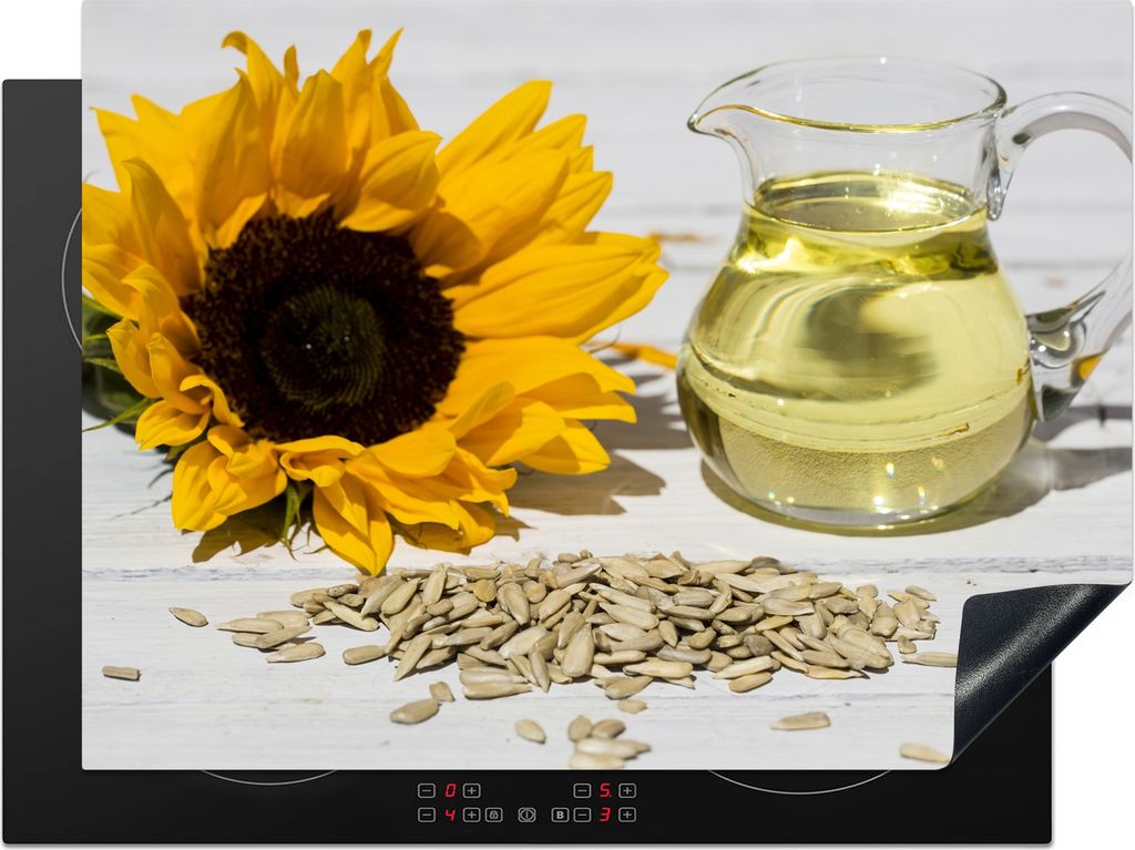 KitchenYeah Herdabdeckplatte Sonnenblumenkerne mit Sonnenblumenöl in einem kleinen Glas und Sonnenblume auf einem weißen Tisch , 71x52cm, Küch...