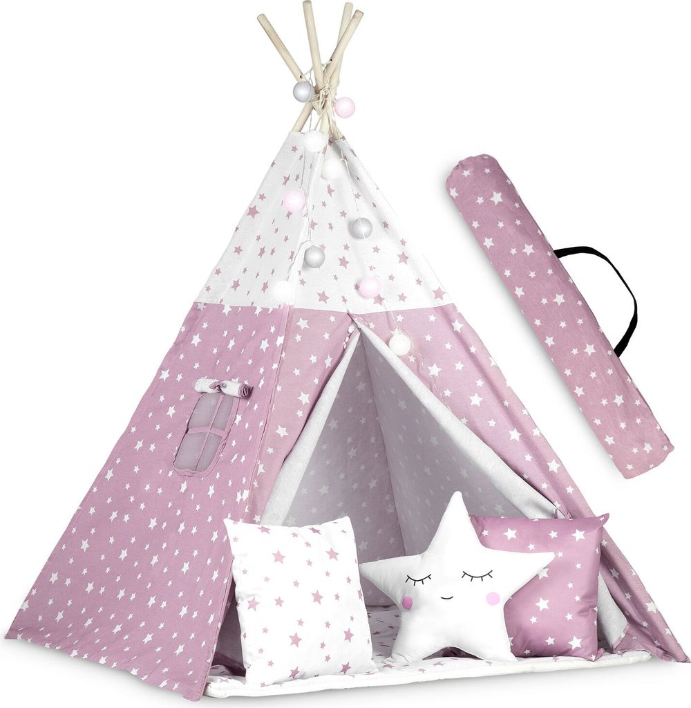 A pink and white star-patterned teepee tent for children, set up indoors with decorative pillows and string lights.