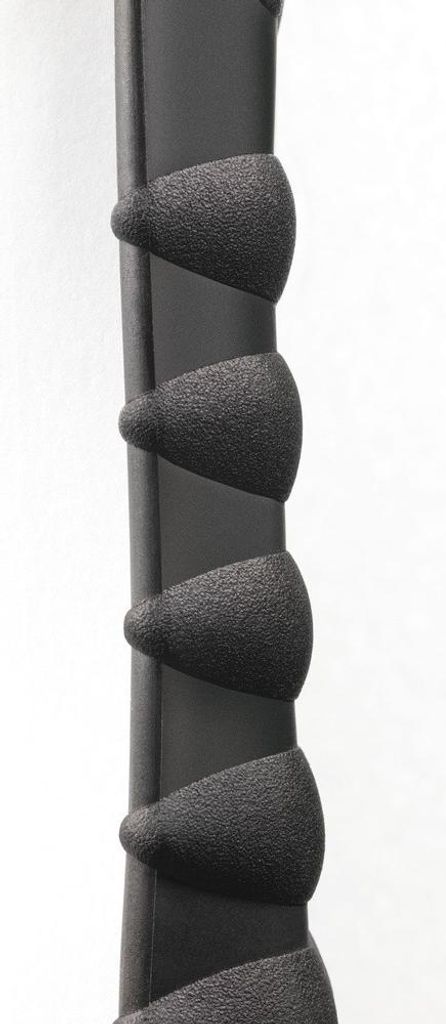 A close-up view of a black textured grip on a dark cylindrical object, likely a handle or part of a device.