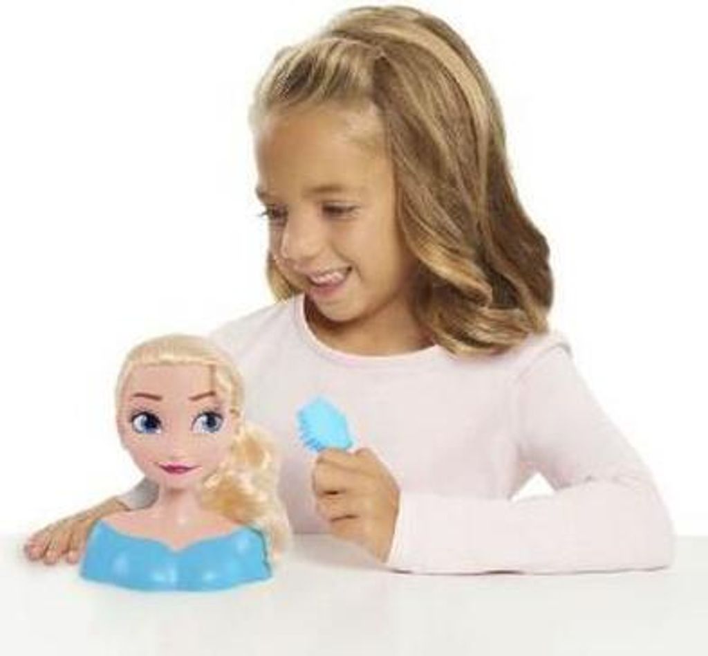 A young girl is playing with a Disney Princess Elsa Mini Styling Head.