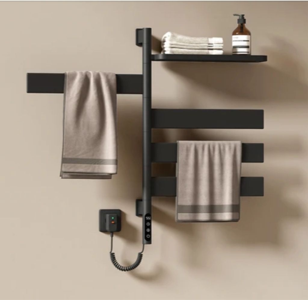 A black electric towel warmer with towels and a soap dispenser on a shelf.