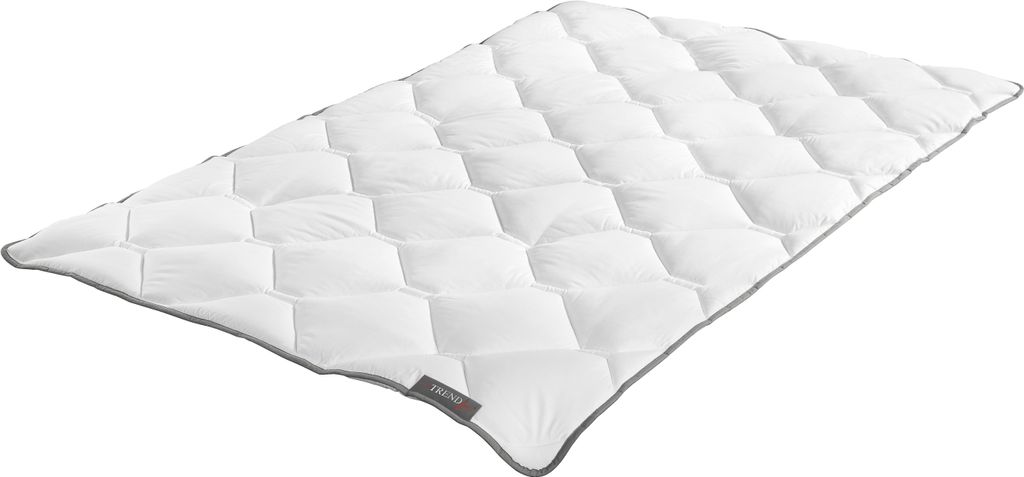 A white quilted comforter is shown laid out on a white background.
