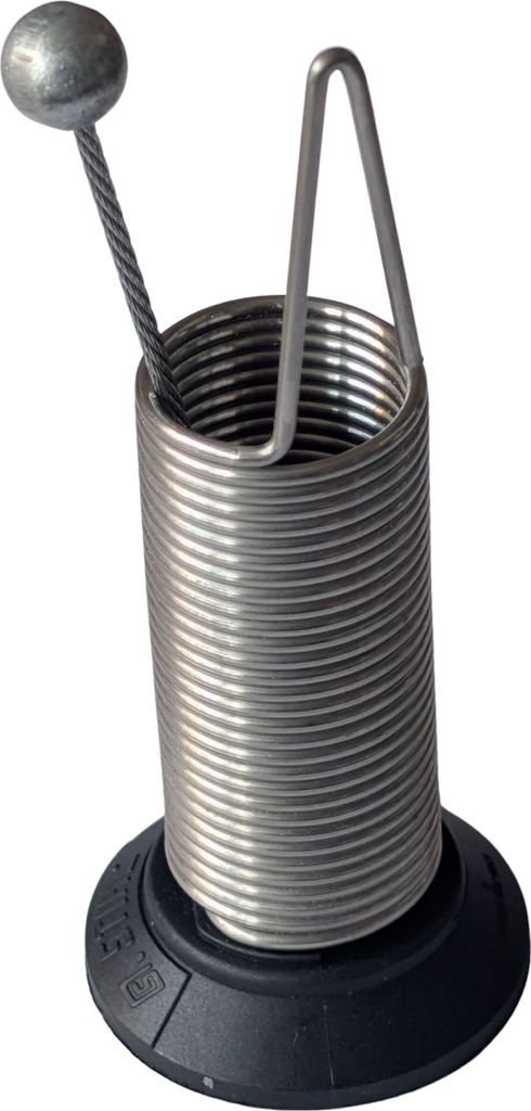 A close-up studio shot of a metal spring mechanism with a ball on a wire attached.