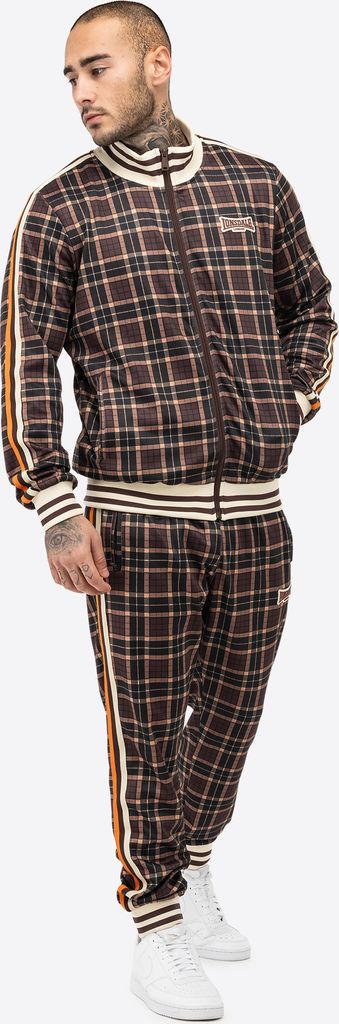 A man wearing a brown plaid tracksuit.