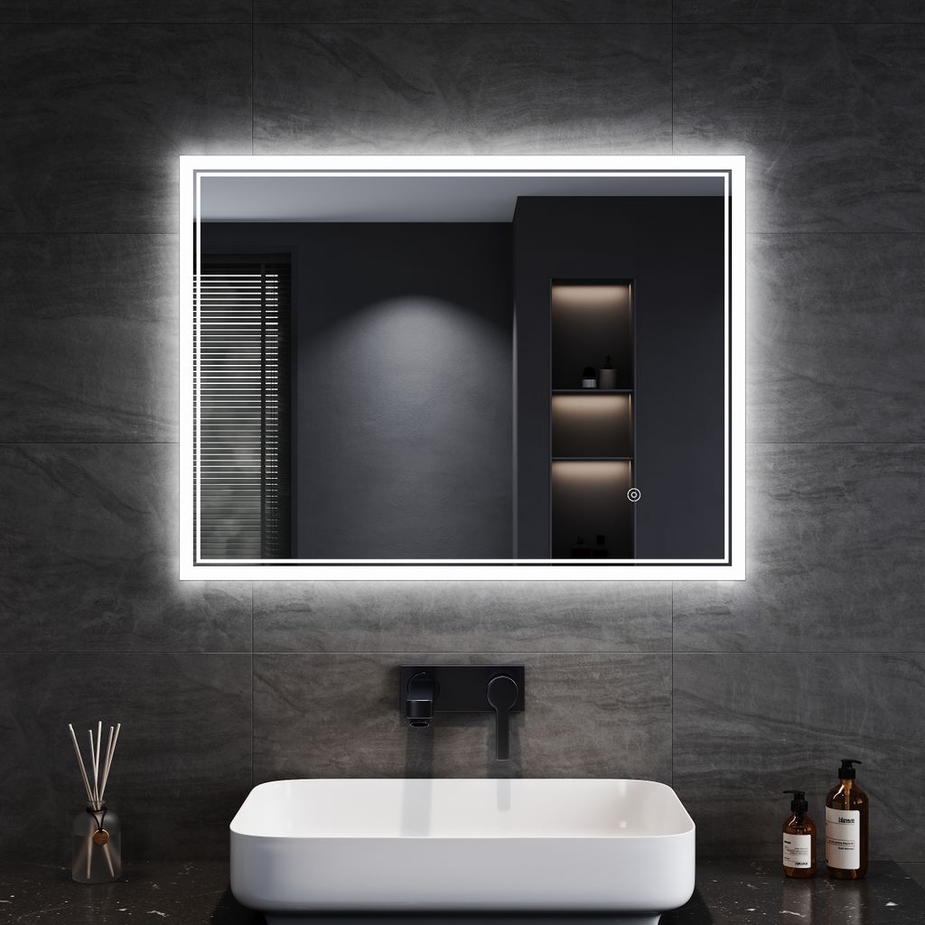 A modern bathroom with a sink and a large LED mirror.