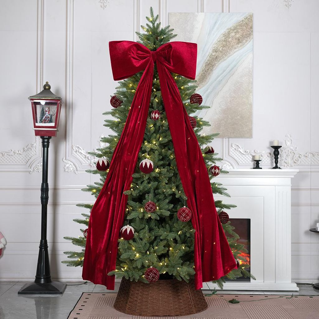 A decorated Christmas tree in a living room setting with a fireplace and a lamp post.