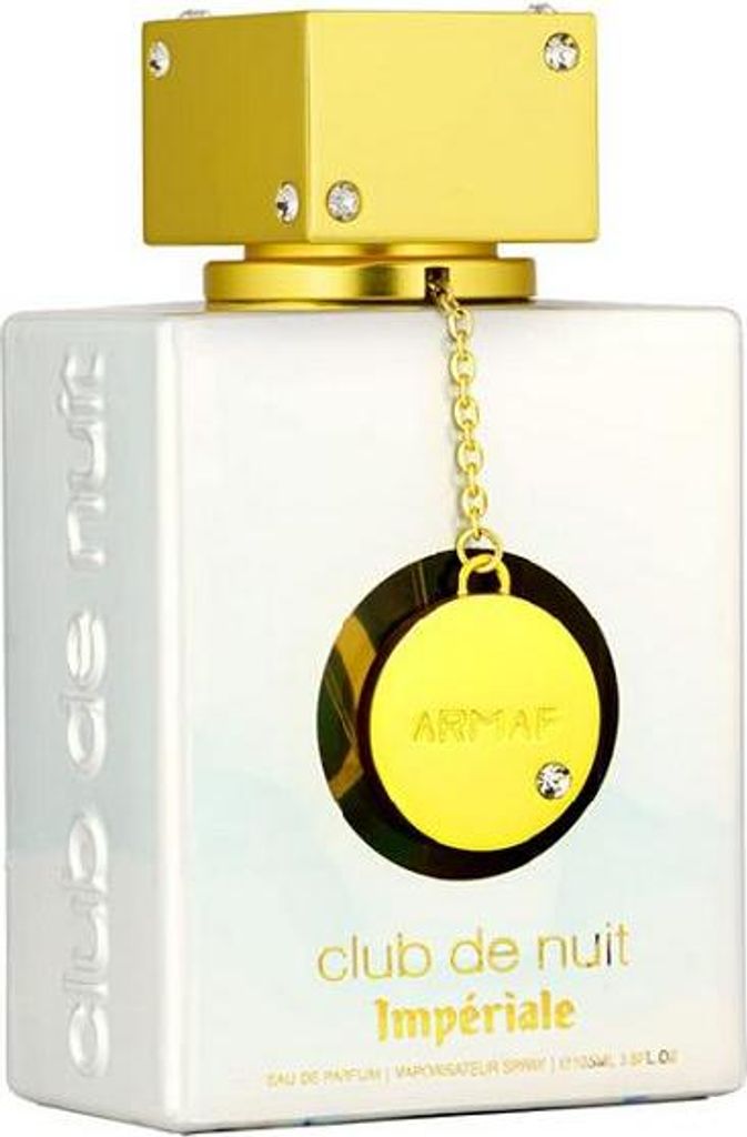 A white perfume bottle with gold accents and a decorative chain with a gold disc.