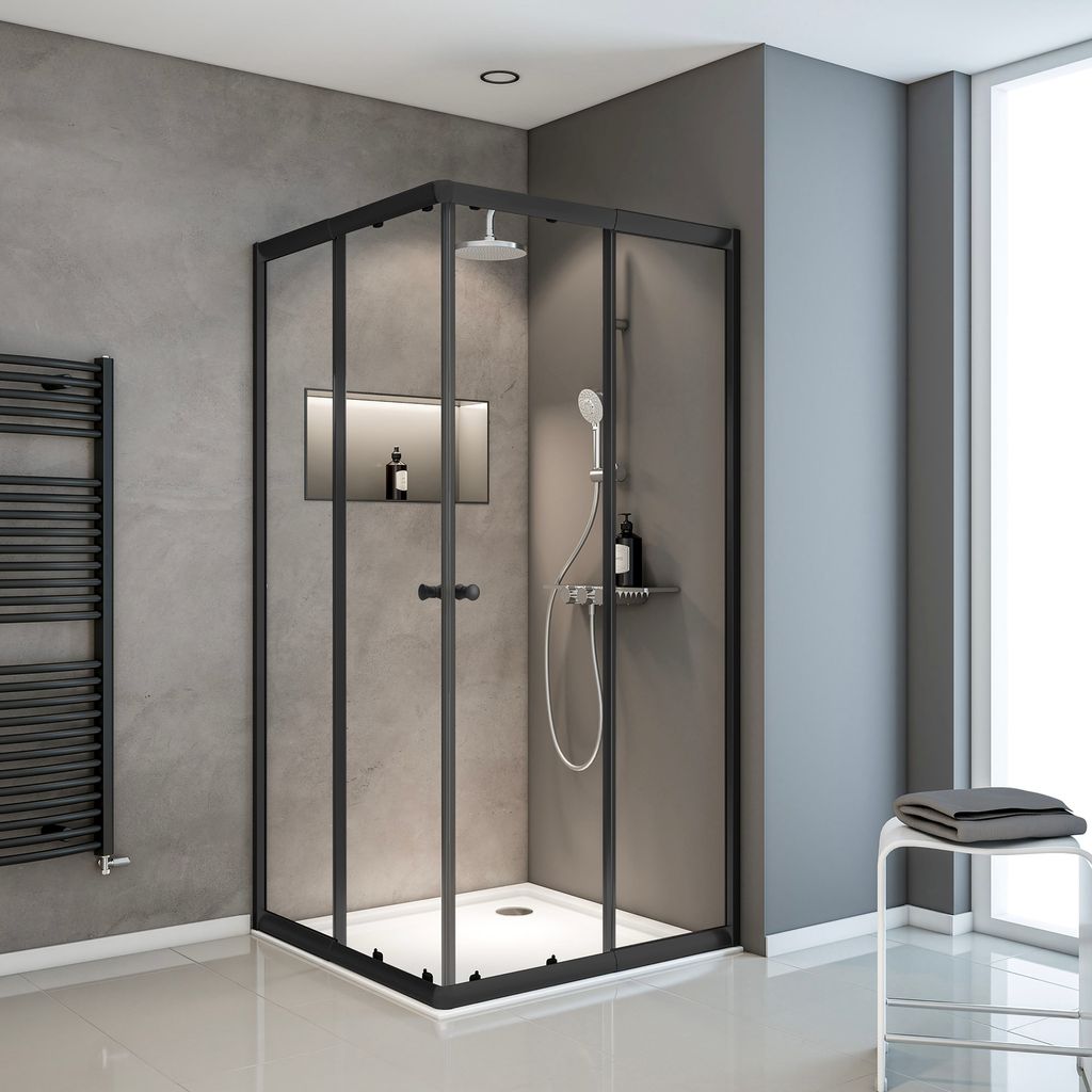 A modern bathroom with a black framed glass shower enclosure.