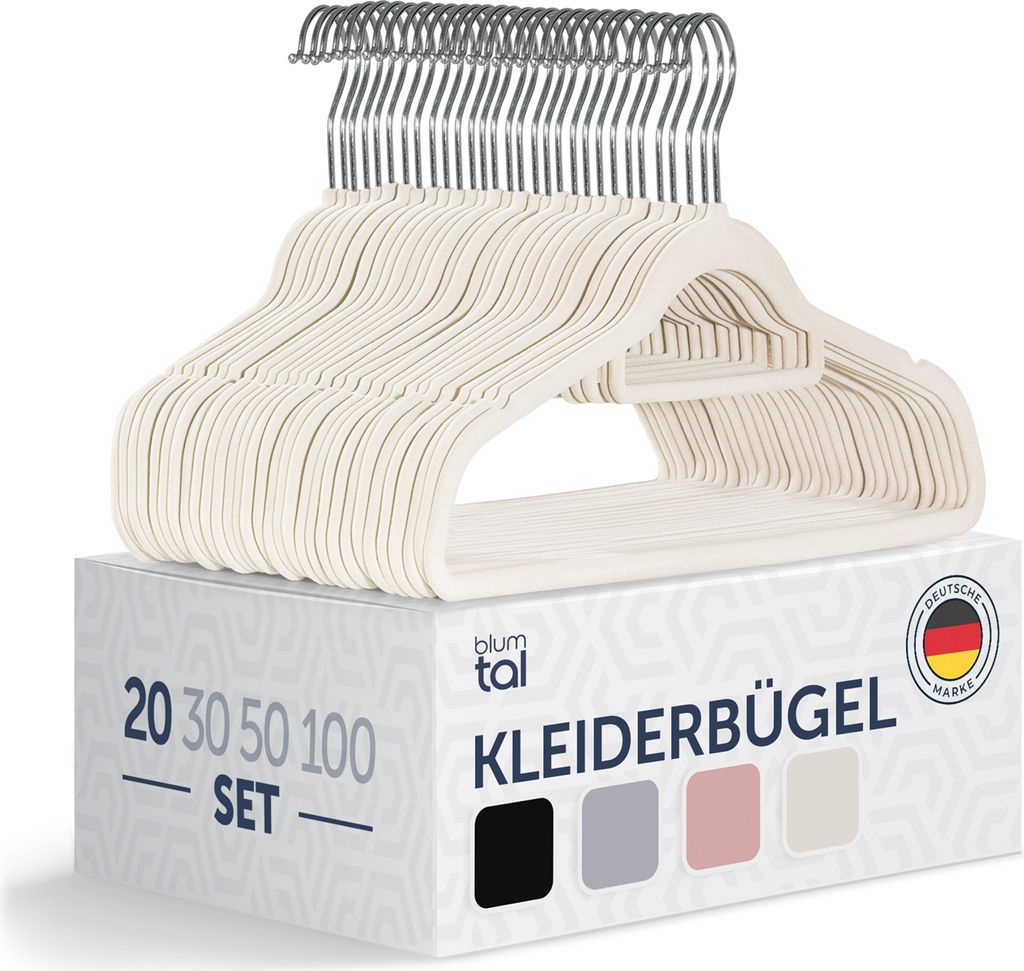 A stack of ivory-colored velvet hangers on top of a product box.