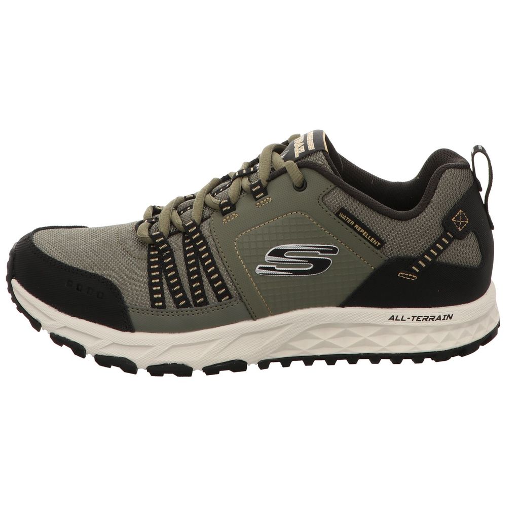 A side view of a single green and black athletic shoe.