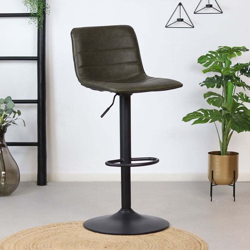 A bar stool in a room with plants and decor.