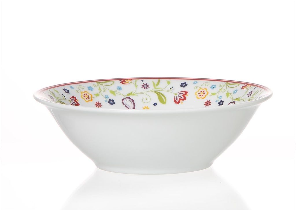 A white ceramic bowl with a floral pattern around the rim, set against a white background.
