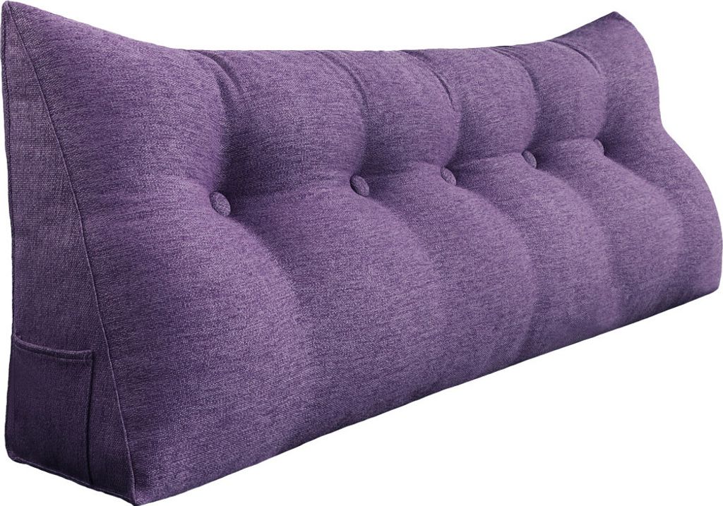 A purple wedge-shaped pillow with button tufting.