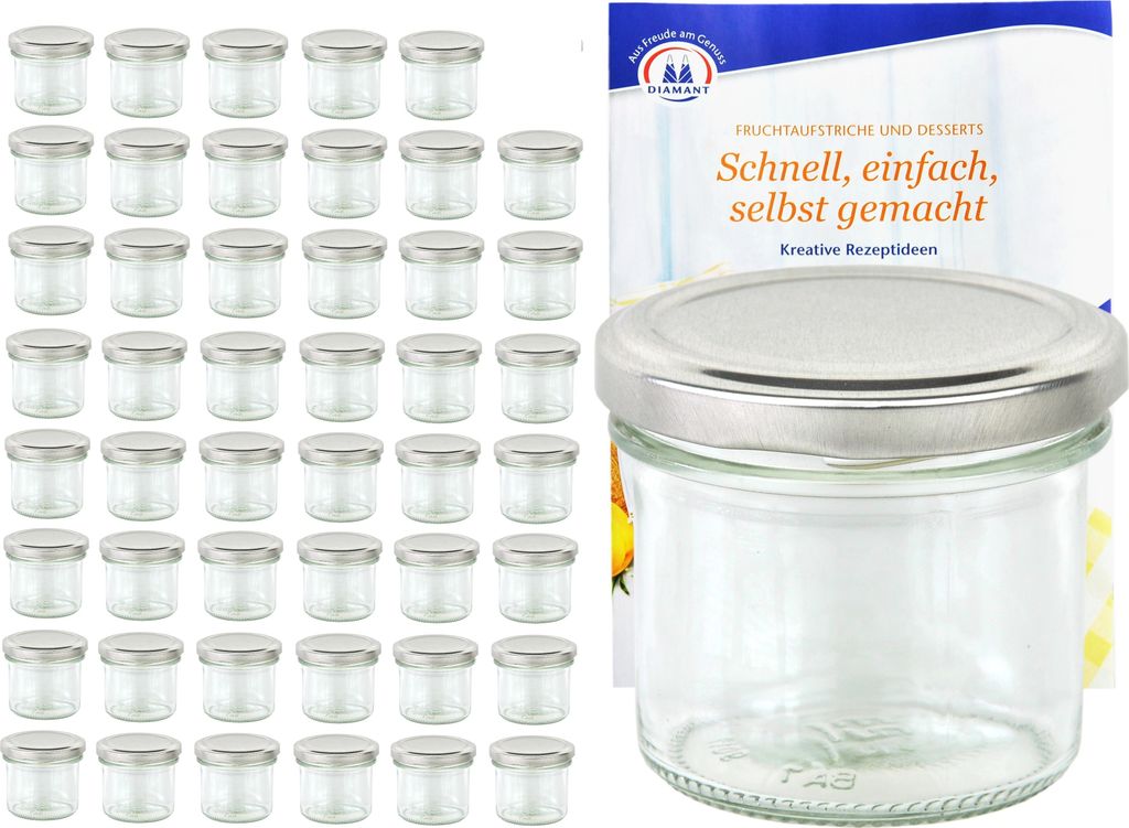 A collection of small glass jars with silver lids, alongside a booklet with text.