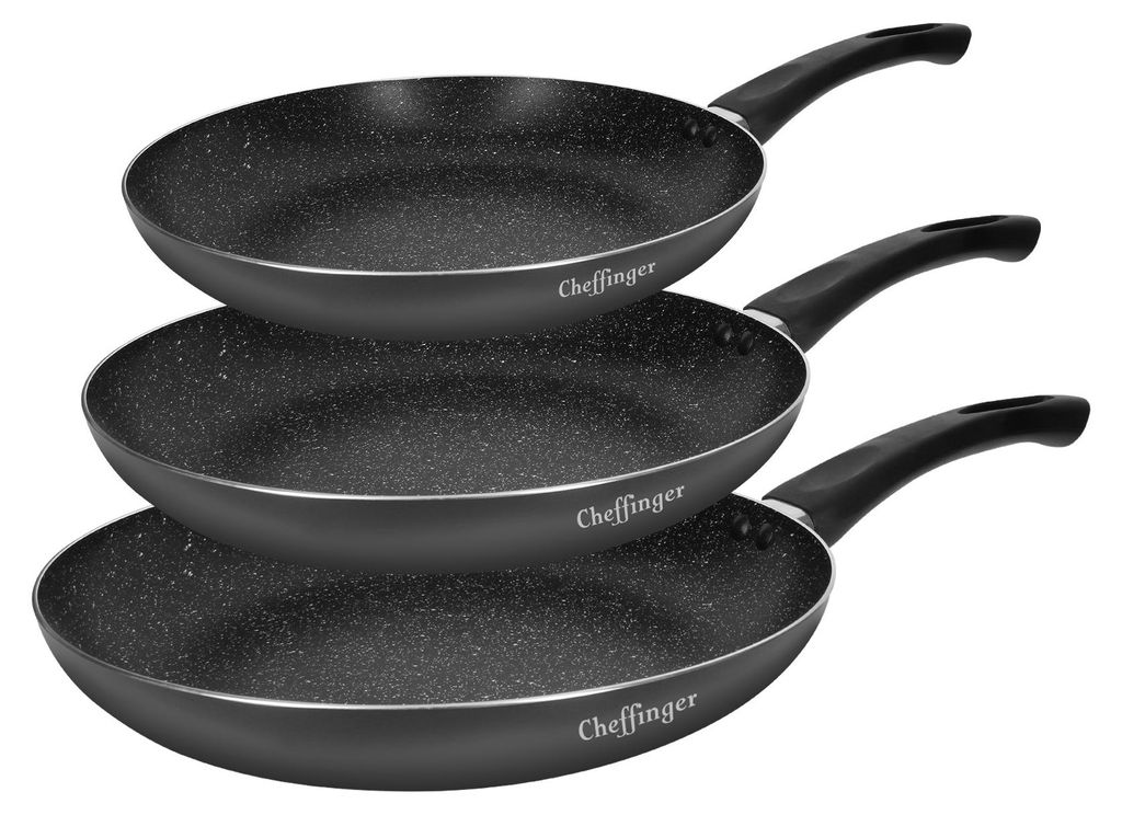 Three stacked frying pans with black handles and speckled gray interiors.
