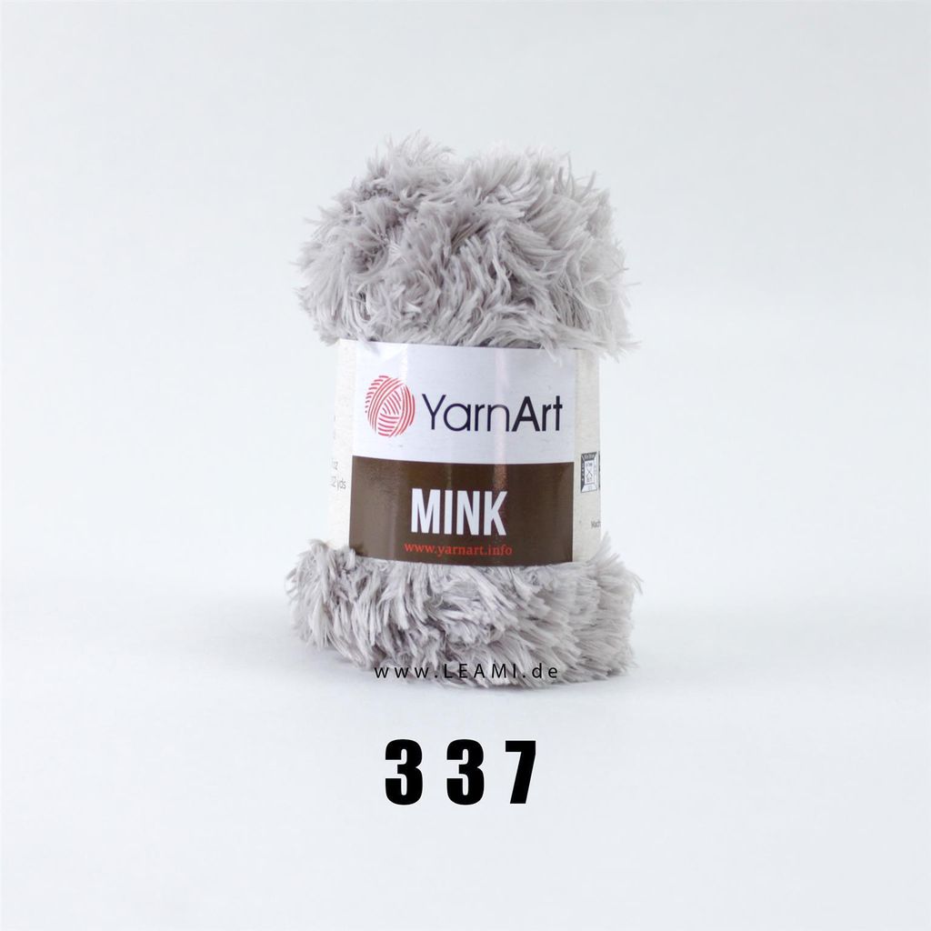A ball of grey, fluffy yarn with a label indicating the brand and product name.