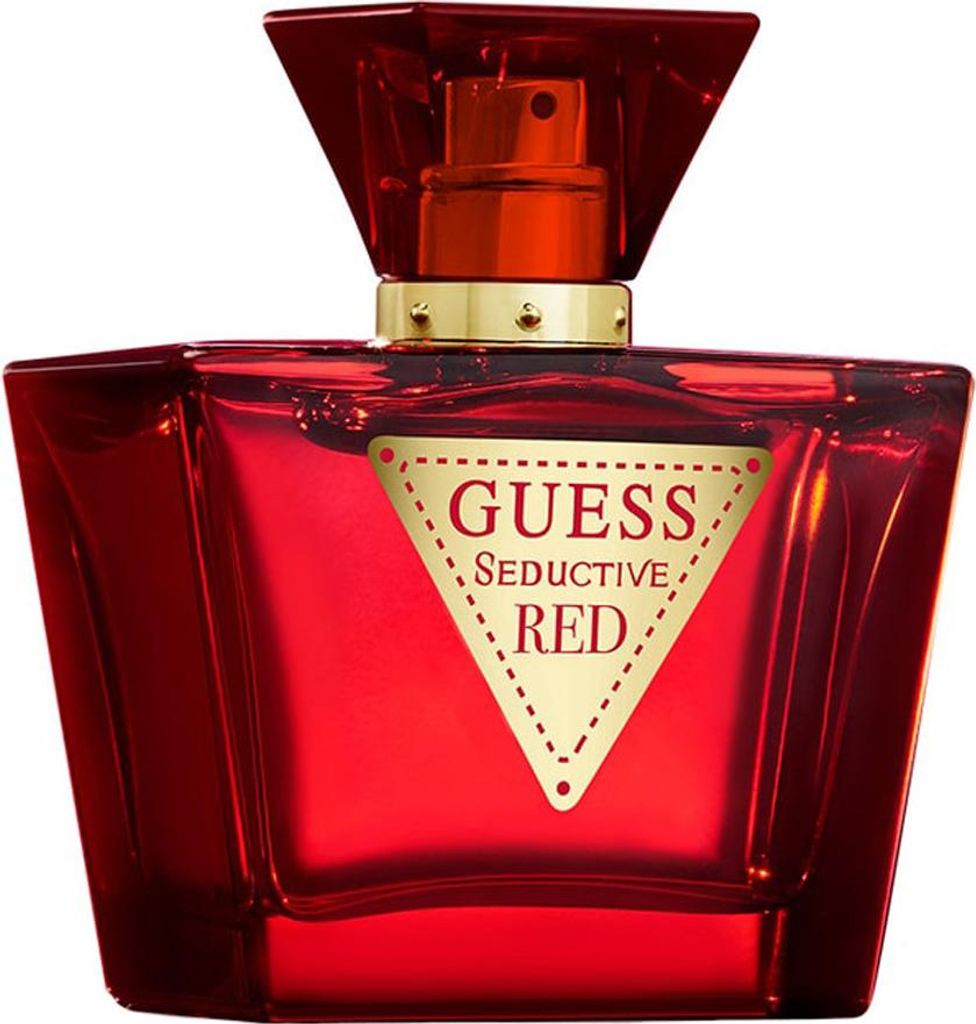A red Guess Seductive Red Eau de Toilette bottle with a gold label.