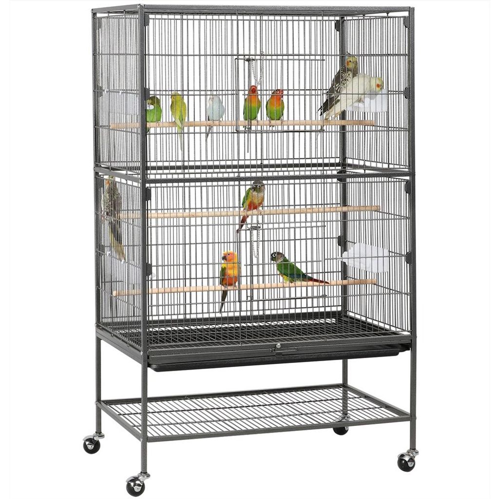 A multi-level bird cage with several birds inside, displayed on a white background.