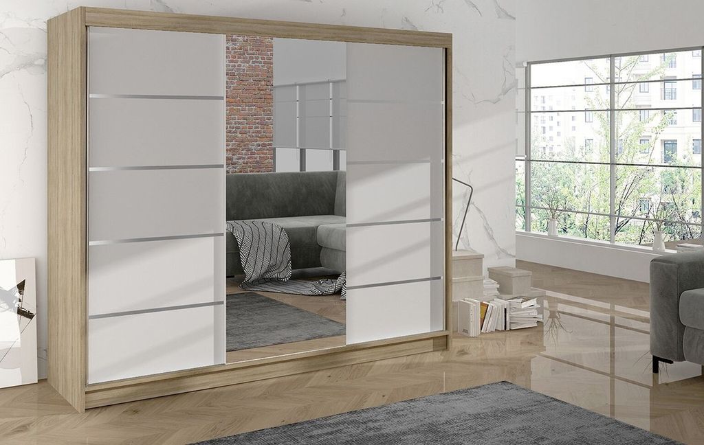 A modern bedroom with a large wardrobe and a window overlooking trees.