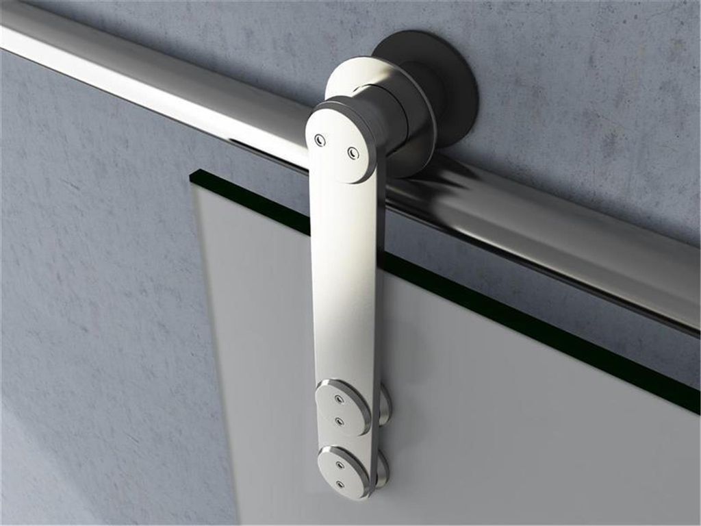 A close-up view of a sliding glass door hardware system mounted on a wall.