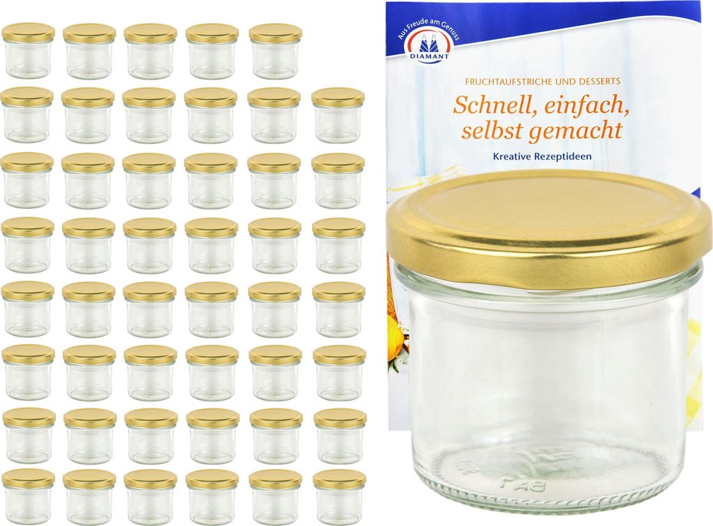 A set of small glass jars with gold lids is displayed next to a recipe booklet.